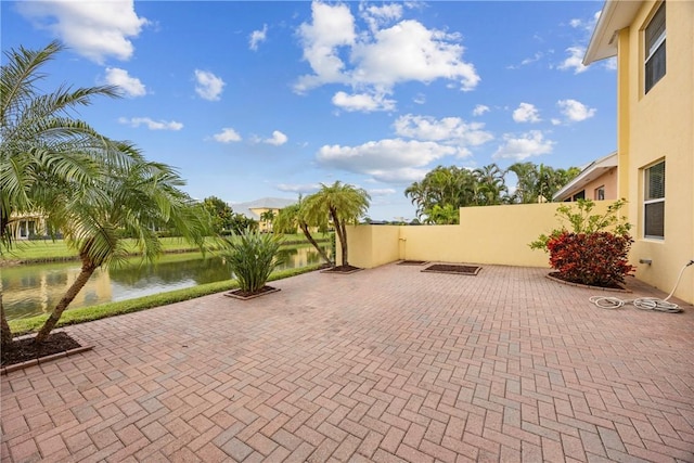 view of patio with a water view