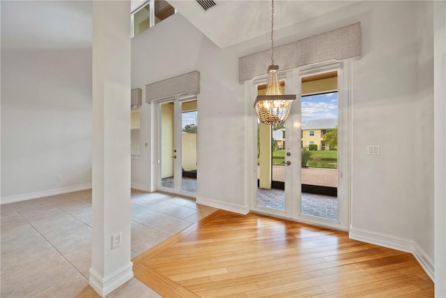 unfurnished dining area with a chandelier and tile patterned floors