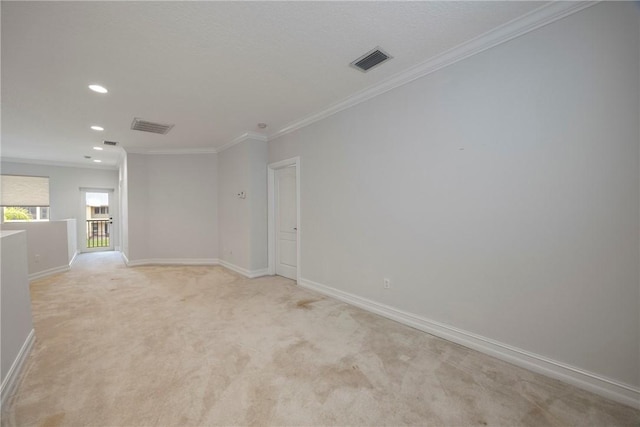 unfurnished room with light colored carpet and crown molding