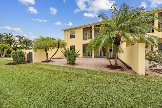 exterior space with a lawn and a patio