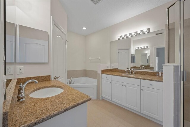 bathroom featuring vanity and independent shower and bath