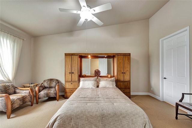 bedroom featuring light colored carpet and ceiling fan