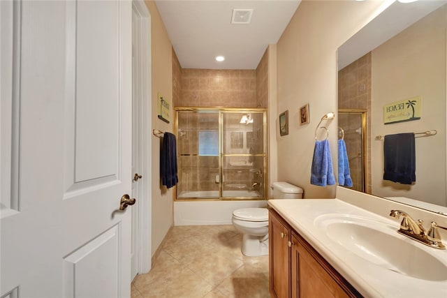 full bathroom featuring bath / shower combo with glass door, vanity, toilet, and tile patterned floors