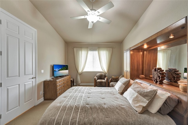 carpeted bedroom with vaulted ceiling and ceiling fan