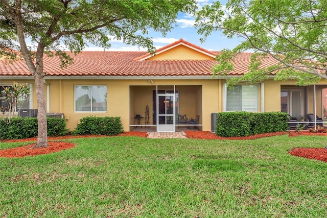 view of front facade with a front lawn and a sunroom