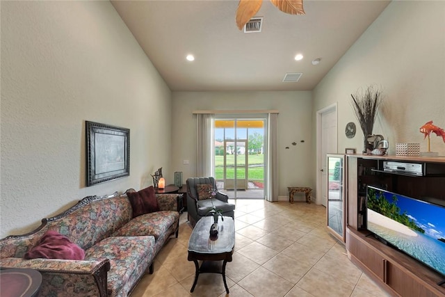 tiled living room with ceiling fan