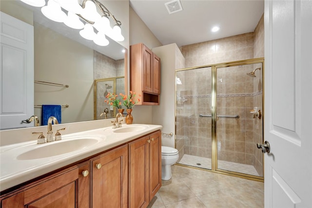 bathroom featuring toilet, a shower with door, tile patterned flooring, and vanity