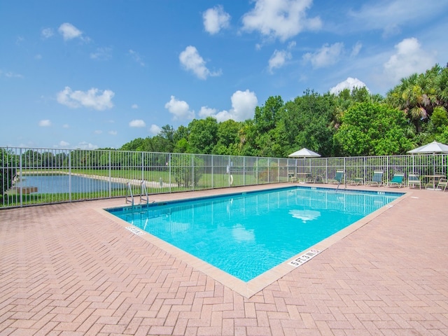 pool featuring a patio and fence