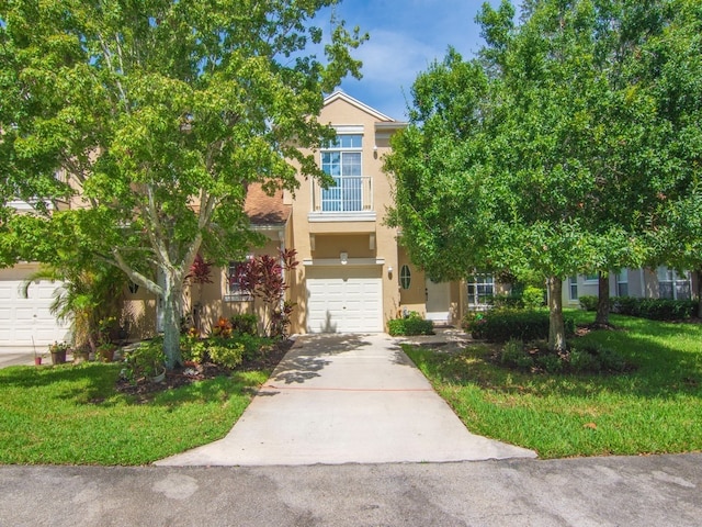 obstructed view of property featuring a garage and a front lawn