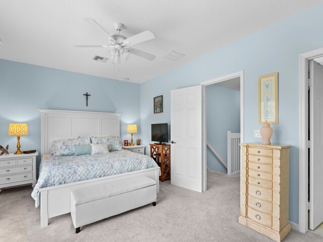 bedroom featuring visible vents, light carpet, and ceiling fan