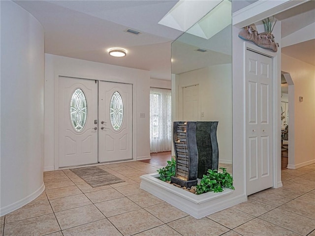 entrance foyer with light tile patterned floors