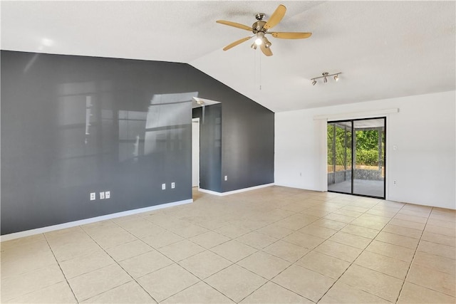 spare room with vaulted ceiling, light tile patterned floors, and a ceiling fan