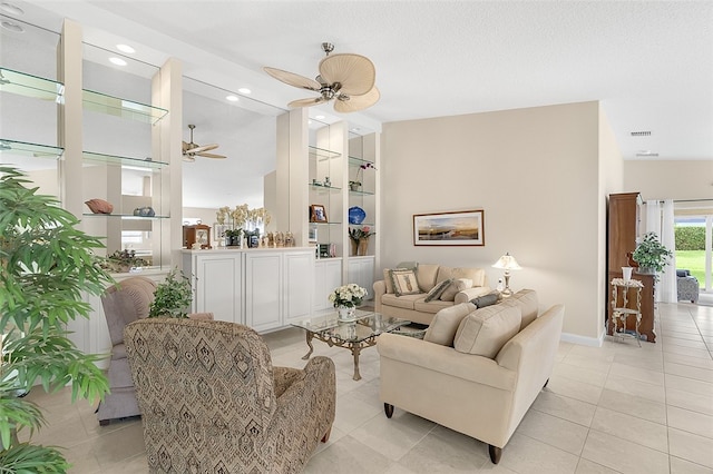 tiled living room featuring ceiling fan and a textured ceiling