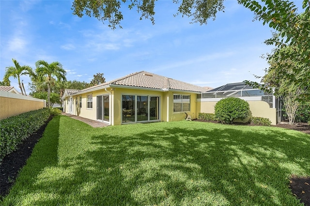 rear view of house with a yard