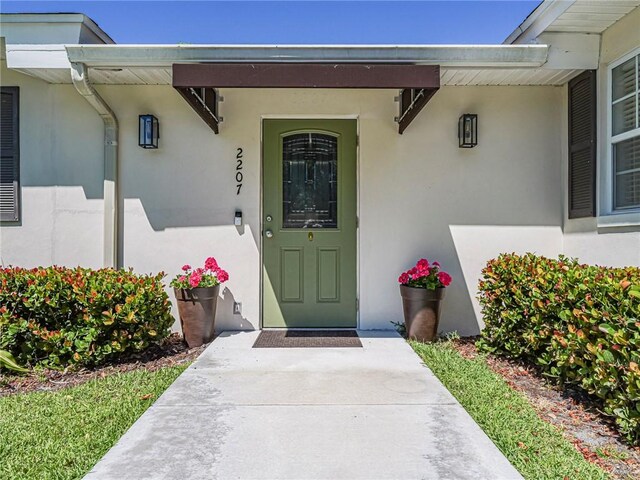 ranch-style house with a front yard and stucco siding