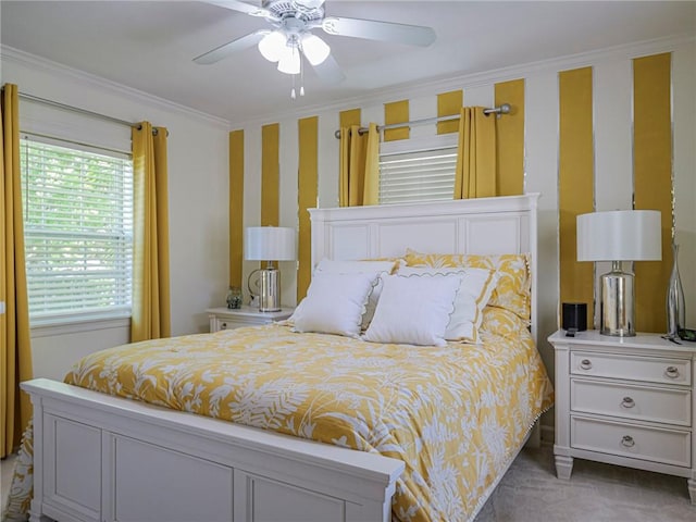 carpeted bedroom featuring wallpapered walls, crown molding, and a ceiling fan