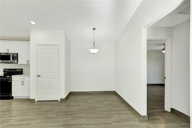 kitchen with decorative light fixtures, white cabinetry, electric range, ceiling fan, and light hardwood / wood-style floors