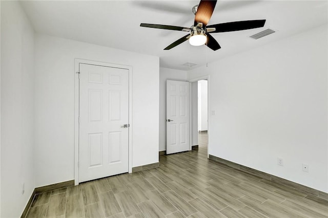 unfurnished bedroom featuring ceiling fan and light wood-type flooring