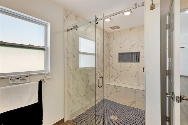 bathroom featuring a shower with shower door