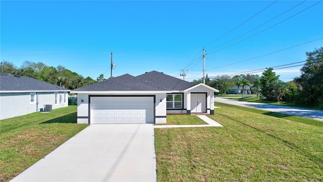 single story home featuring central AC, a garage, and a front lawn