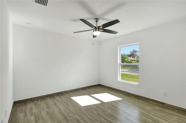 spare room featuring ceiling fan and light wood-type flooring