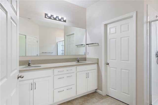 bathroom featuring walk in shower, vanity, and tile patterned floors