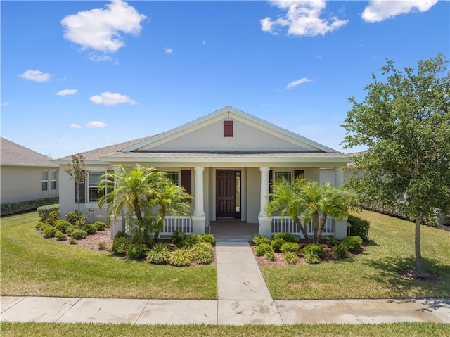 view of front of house with a front yard and a porch