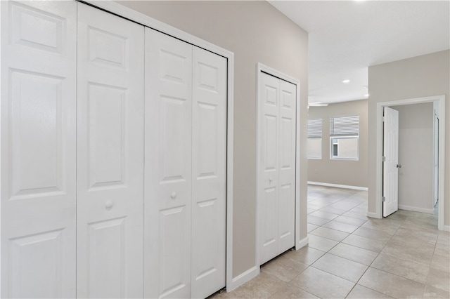 hall featuring light tile patterned floors