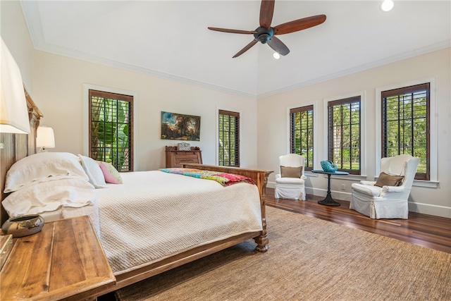 bedroom featuring dark hardwood / wood-style flooring, ceiling fan, and crown molding