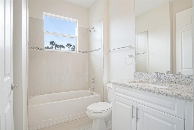 full bathroom with vanity, tiled shower / bath combo, and toilet