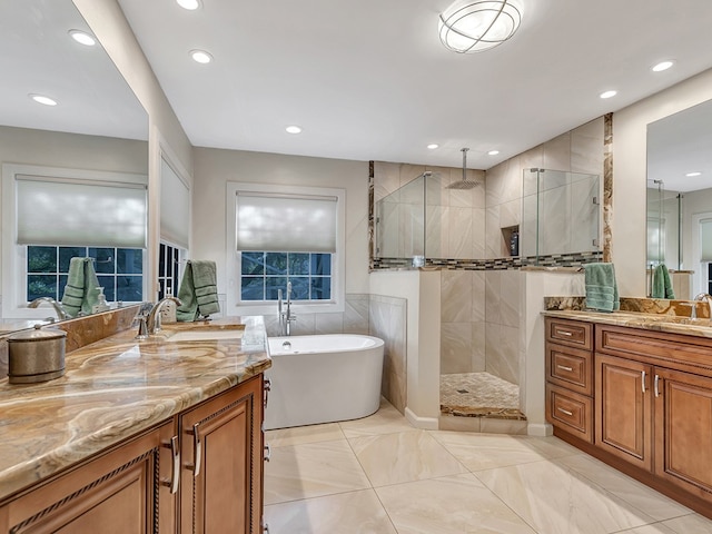 bathroom with vanity and shower with separate bathtub