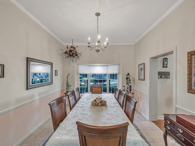 tiled dining room featuring an inviting chandelier and crown molding