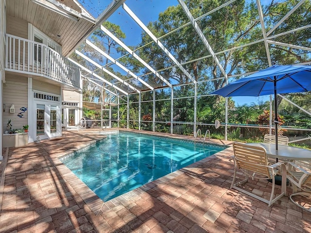 1516 50th Ct, Vero Beach, FL 32966 - outdoor pool with french doors, a patio, and glass enclosure