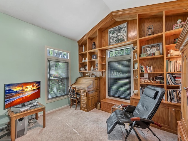 office with lofted ceiling and light carpet