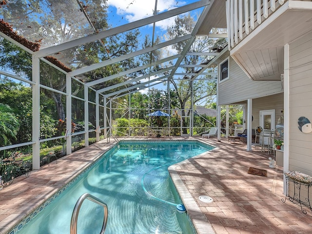 view of pool with a lanai and a patio