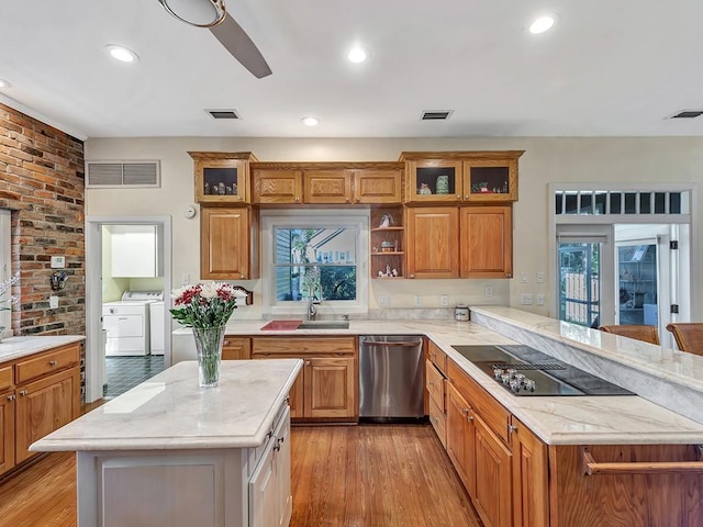 1516 50th Ct, Vero Beach, FL 32966 - kitchen with dishwasher, black electric stovetop, washing machine and clothes dryer, light wood-type flooring, and recessed lighting