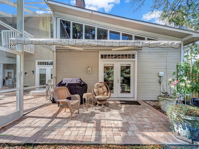 rear view of house featuring french doors and a patio area