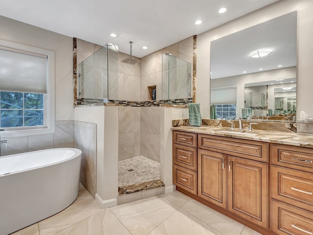 bathroom with vanity, shower with separate bathtub, and tile patterned floors