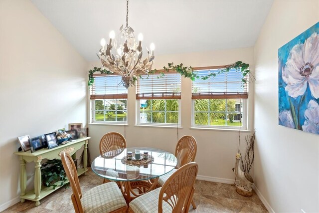 dining space with a chandelier and lofted ceiling