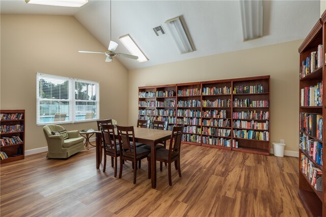 dining area featuring hardwood / wood-style floors, ceiling fan, and high vaulted ceiling