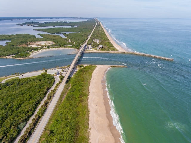 bird's eye view with a water view and a beach view