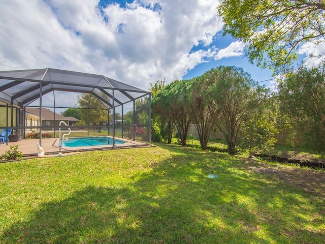 view of yard featuring glass enclosure and an outdoor pool