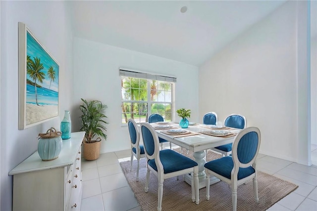 dining space featuring light tile patterned floors and lofted ceiling