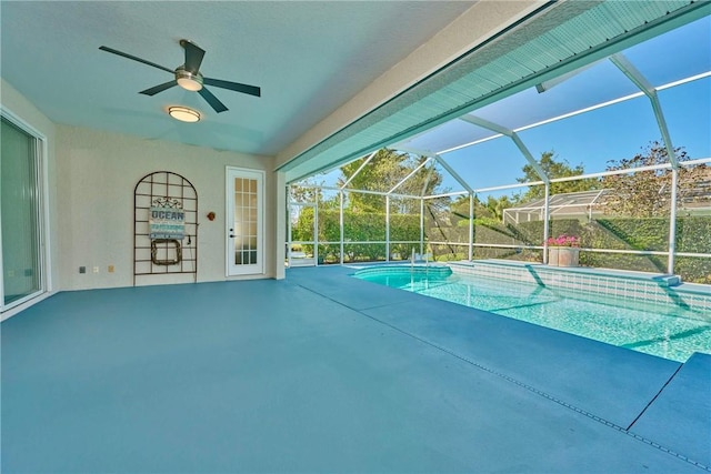 pool with a ceiling fan, glass enclosure, and a patio area