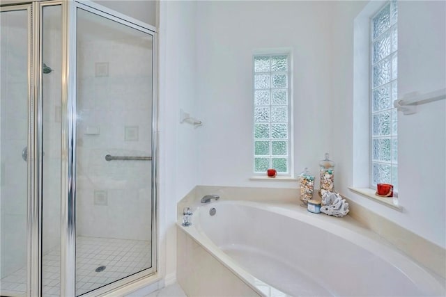 full bath featuring a garden tub and a stall shower