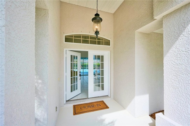 entrance to property featuring stucco siding