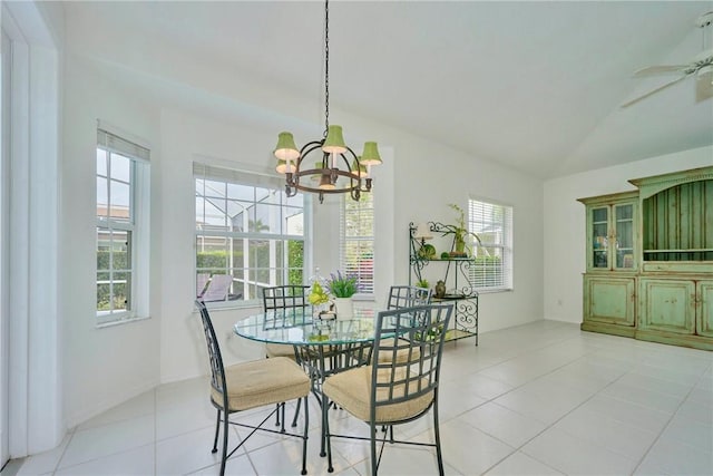 dining space with lofted ceiling, light tile patterned floors, and ceiling fan with notable chandelier