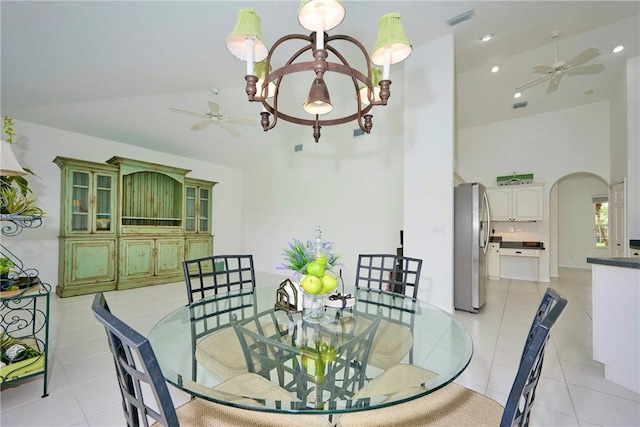 dining room featuring light tile patterned flooring, visible vents, arched walkways, and ceiling fan