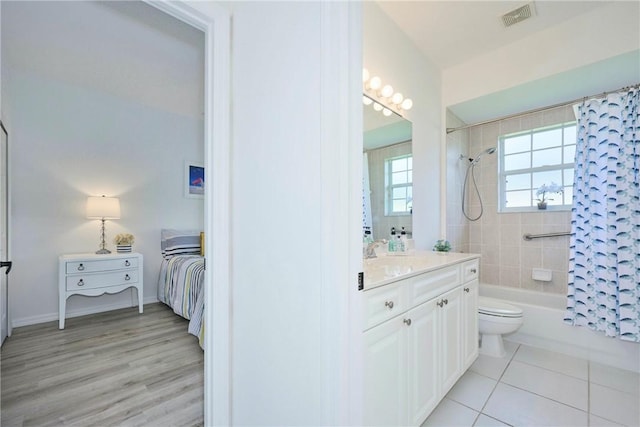 full bathroom with vanity, visible vents, toilet, shower / tub combo with curtain, and connected bathroom