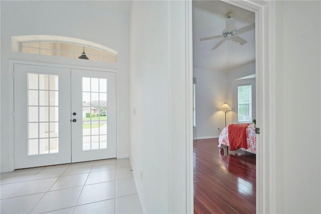 tiled foyer featuring french doors, baseboards, and ceiling fan